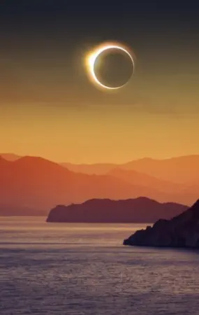 A photo illustration of a total eclipse above a scenic, rural, water-based tourism destination in Europe.